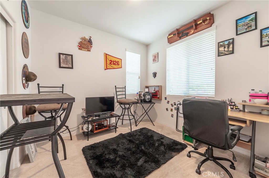 27283 Chase Road Menifee, CA 92584 - Photo 7 of 16 a room with furniture a flat screen tv and a window