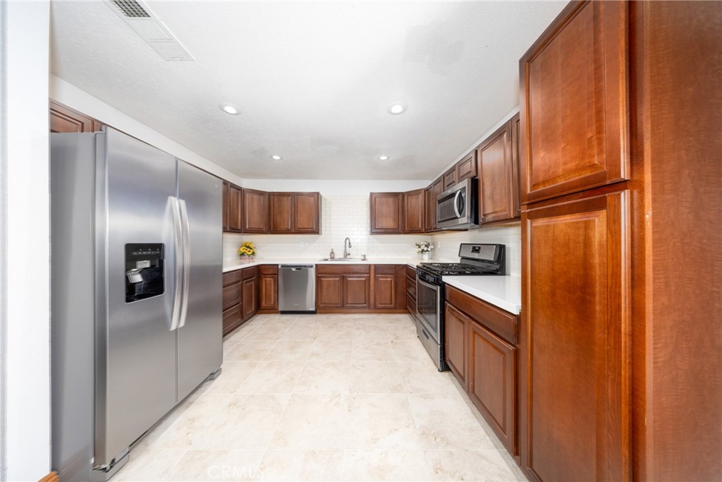 10514 Cameo Court Riverside, CA 92505 - Photo 11 of 30 a kitchen with stainless steel appliances granite countertop a refrigerator and a sink