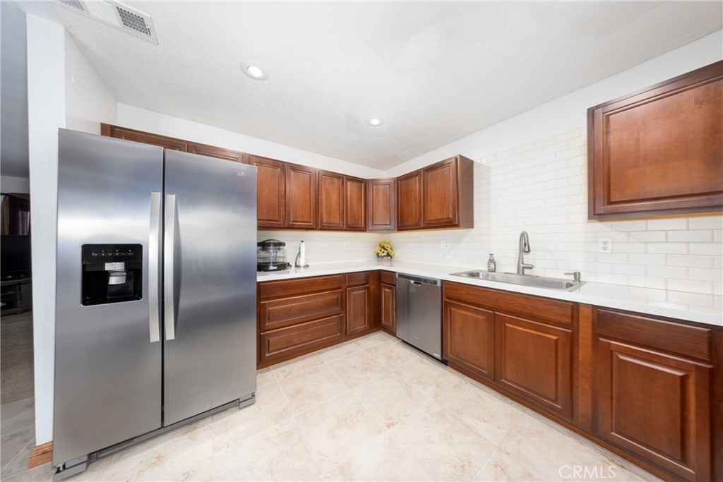 10514 Cameo Court Riverside, CA 92505 - Photo 12 of 30 a kitchen with stainless steel appliances granite countertop a sink stove and refrigerator