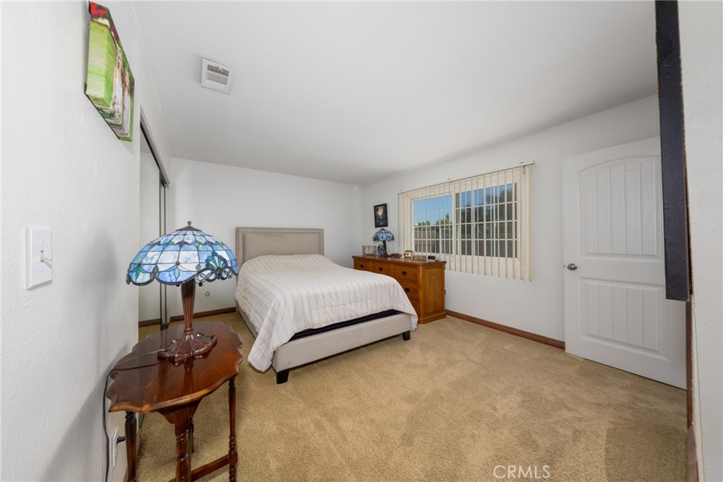 10514 Cameo Court Riverside, CA 92505 - Photo 19 of 30 a bedroom with a bed and a window