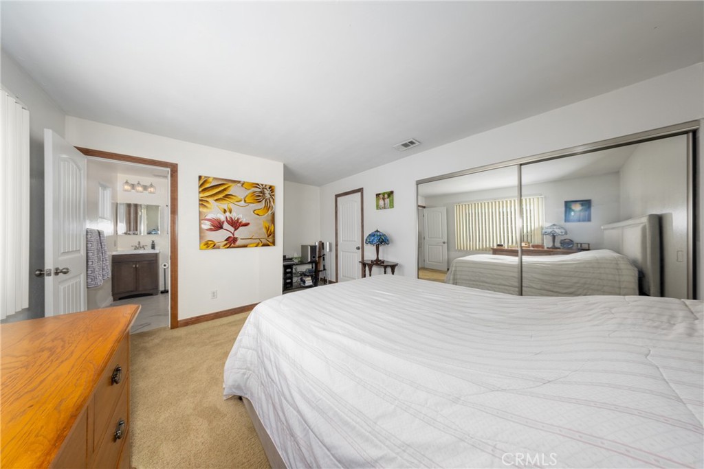 10514 Cameo Court Riverside, CA 92505 - Photo 20 of 30 a bed room with a bed and a large mirror