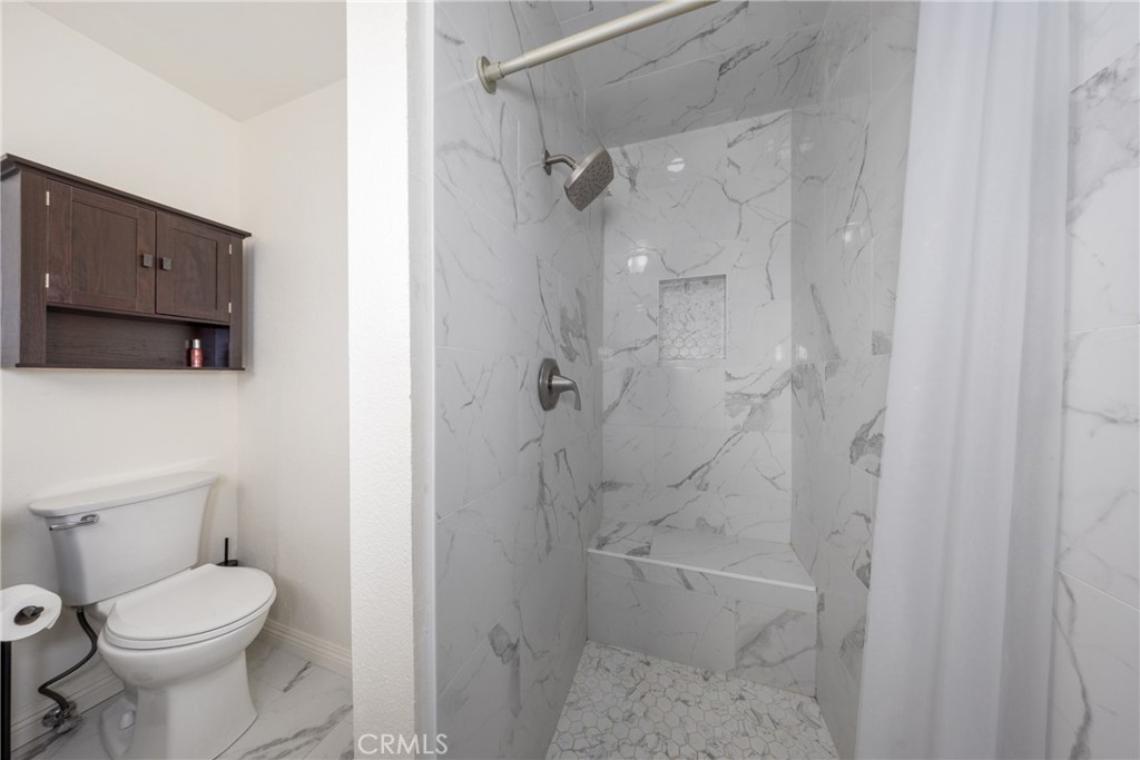 10514 Cameo Court Riverside, CA 92505 - Photo 21 of 30 a bathroom with a toilet and shower