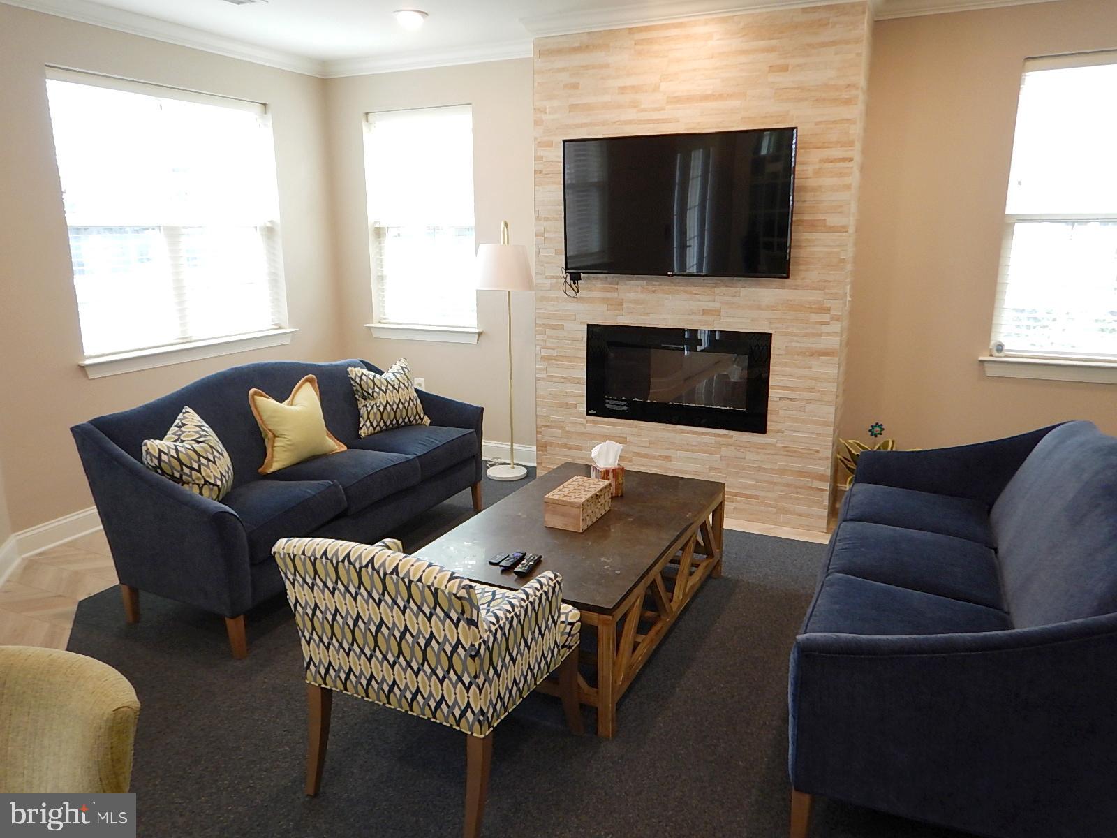 633 Wallingford Road, Unit 201 Bel Air, MD 21014 - Photo 35 of 38 a living room with furniture a flat screen tv and a fireplace