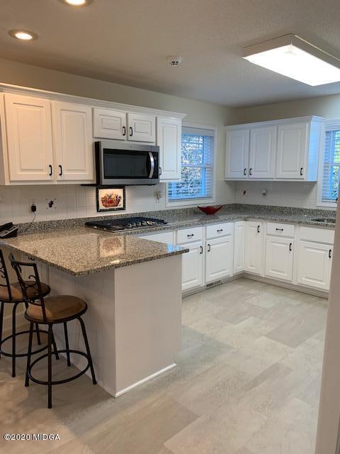 132 Brook Road Barnesville, GA 30204 - Photo 14 of 33 a kitchen with stainless steel appliances granite countertop a stove a sink dishwasher and a microwave