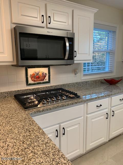 132 Brook Road Barnesville, GA 30204 - Photo 15 of 33 a kitchen with white cabinets stainless steel appliances and sink