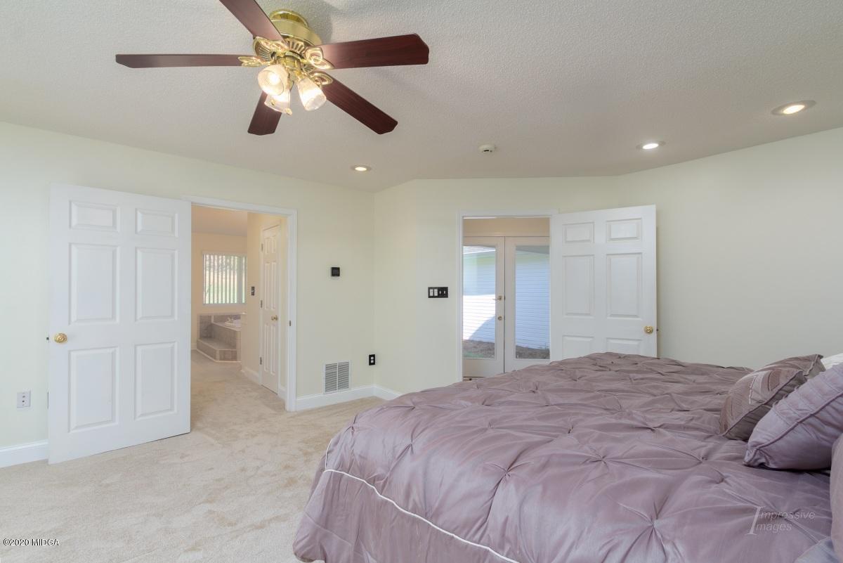 132 Brook Road Barnesville, GA 30204 - Photo 20 of 33 a spacious bedroom with a large bed and a ceiling fan