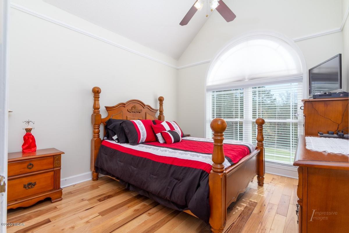 132 Brook Road Barnesville, GA 30204 - Photo 25 of 33 a bedroom with a bed and wooden floor