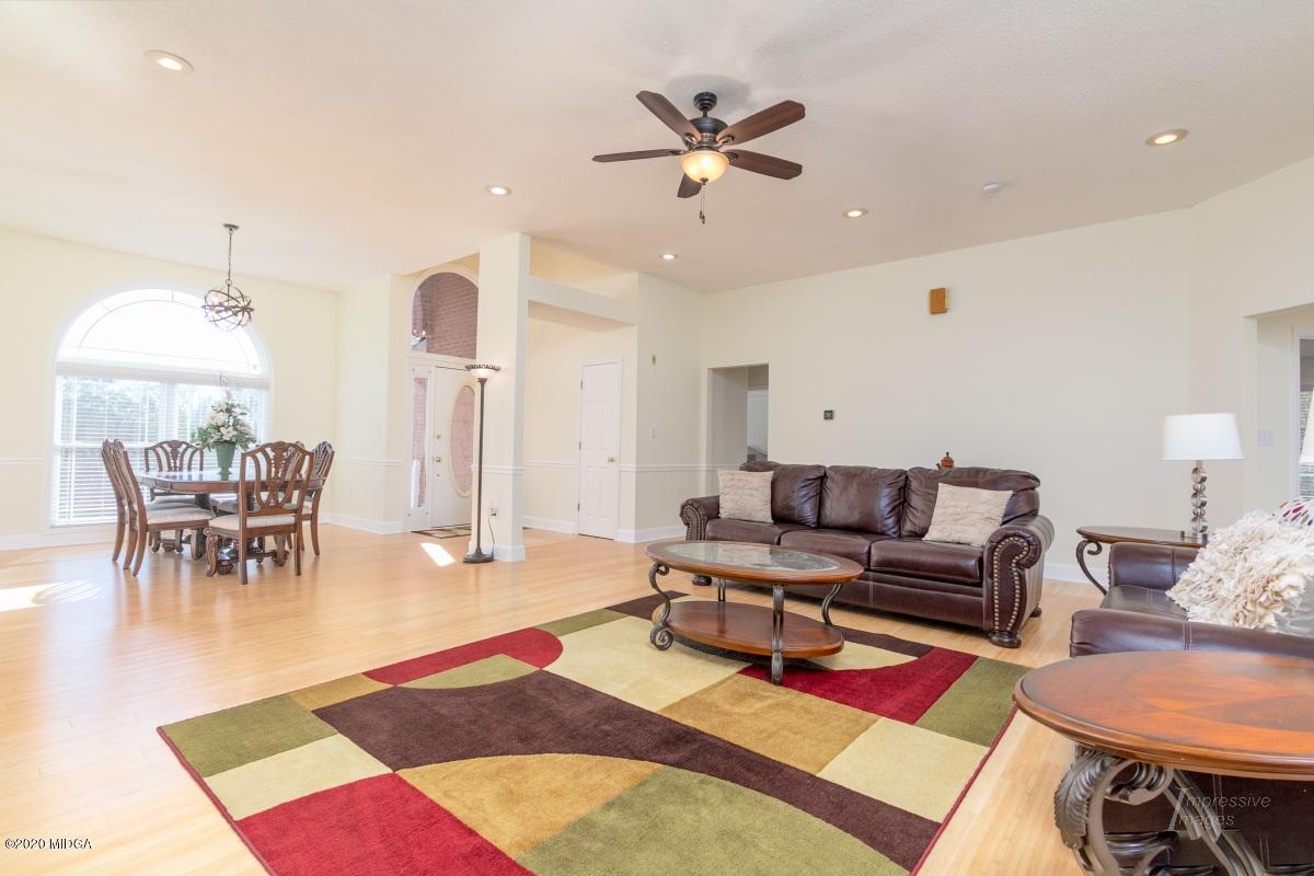 132 Brook Road Barnesville, GA 30204 - Photo 5 of 33 a living room with furniture a rug and a chandelier