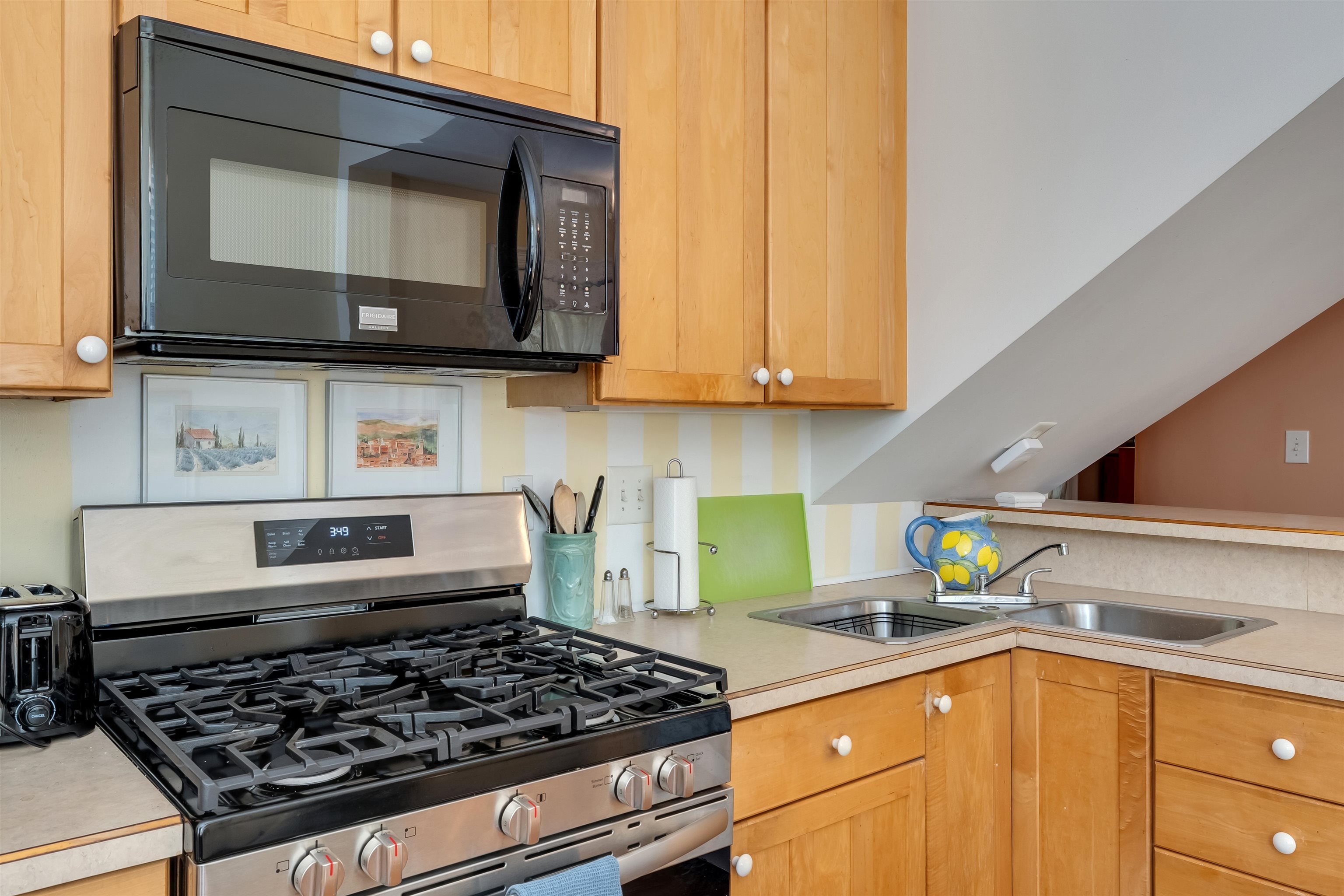 130 Decatur Street Cape May, NJ 08204 - Photo 19 of 50 a kitchen with stainless steel appliances granite countertop a stove and a microwave