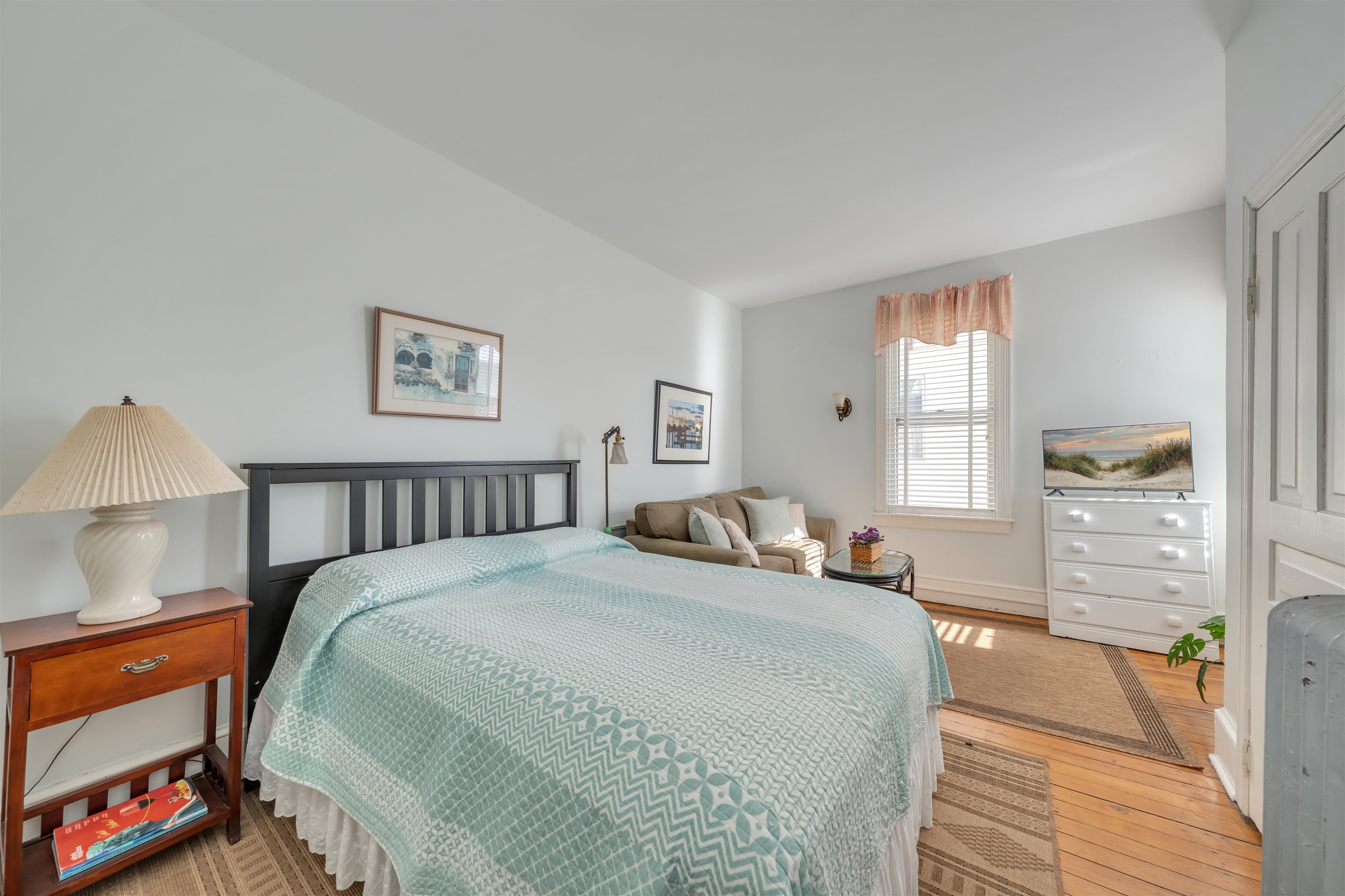 130 Decatur Street Cape May, NJ 08204 - Photo 32 of 50 a bedroom with a bed and a lamp on dresser