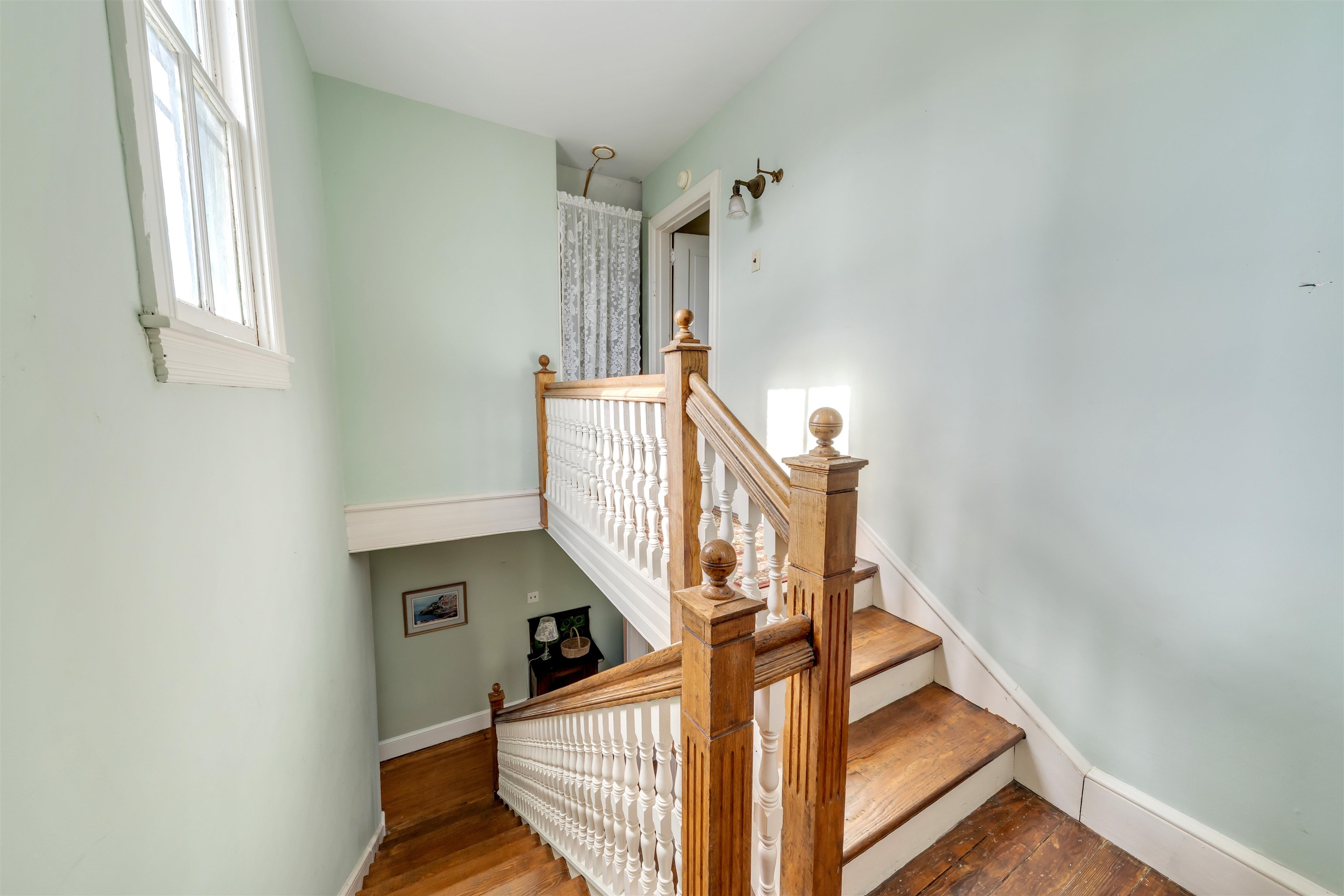 130 Decatur Street Cape May, NJ 08204 - Photo 37 of 50 a view of staircase with lots of frames on wall and a window