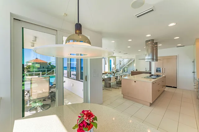 a spacious bedroom with a bed and a flat tv screen on the dresser