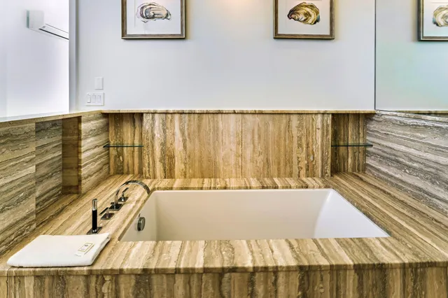 a spacious bedroom with a bed and a large window