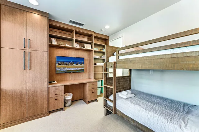 a spacious bedroom with a bed and a large window