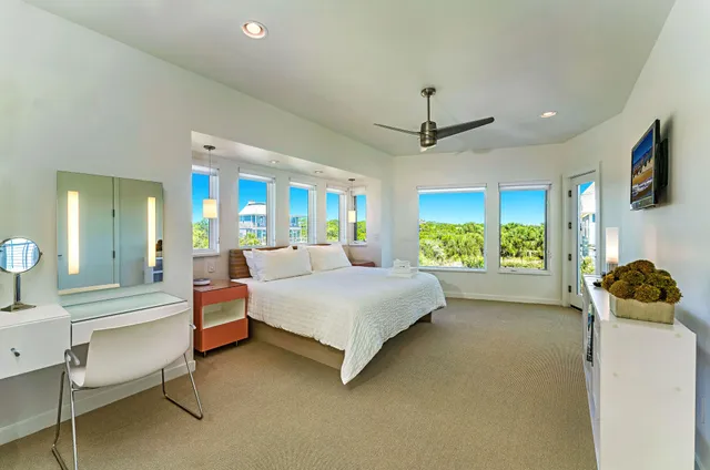 a bedroom with bed and a chandelier