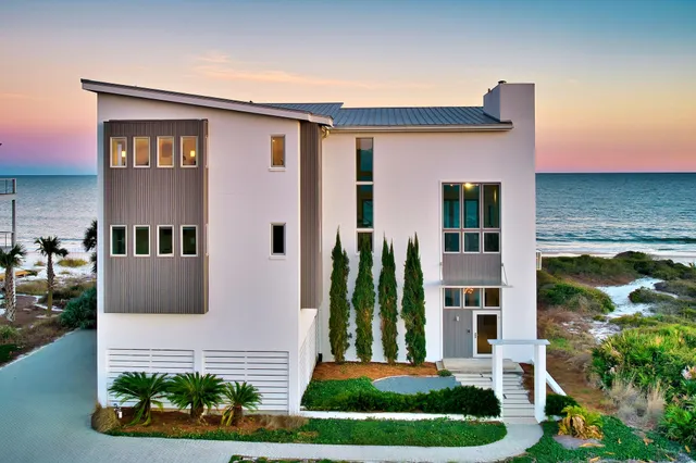 a front view of a residential apartment building with a yard