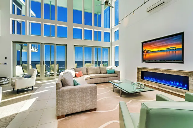 a view of a patio with couches table and chairs and potted plants