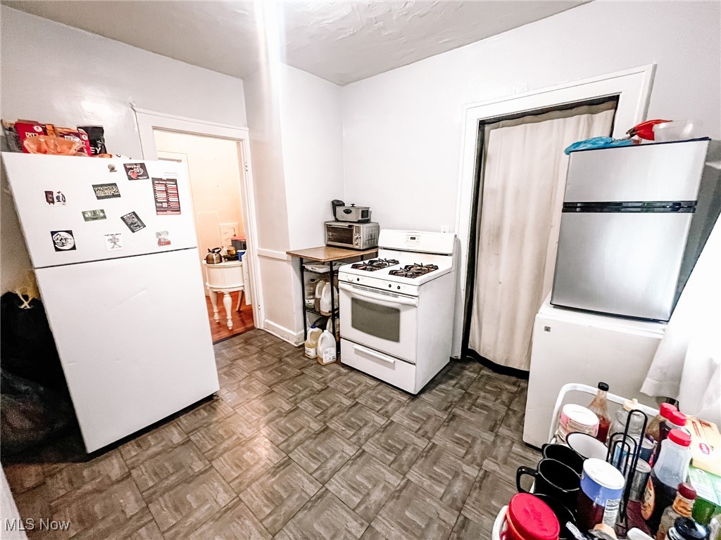 1547 Hillcrest Road Cleveland, OH 44118 - Photo 6 of 23 First Floor Kitchen with parquet floors and white appliances