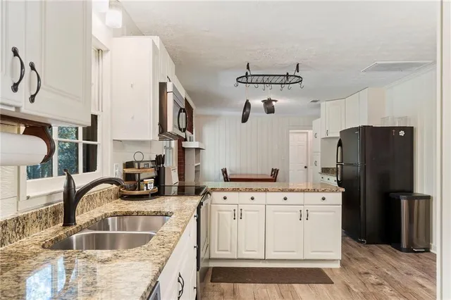 a kitchen with a sink stove and refrigerator