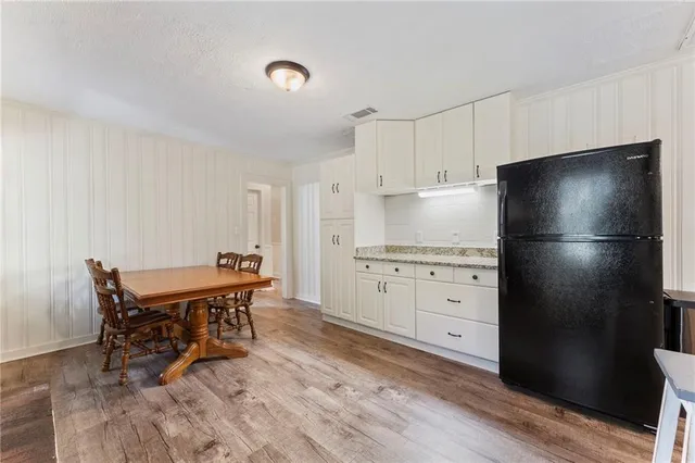 a kitchen with appliances cabinets and wooden floor