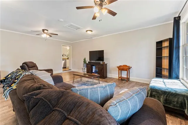 a living room with furniture flat screen tv and a window