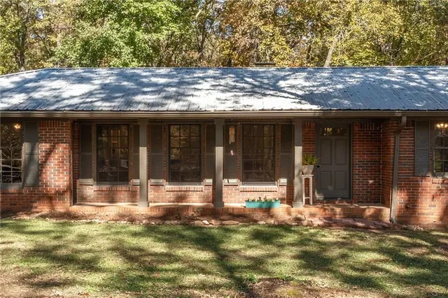 a view of a house with a yard and sitting area