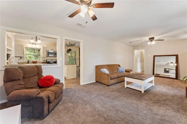 a living room with furniture and a chandelier