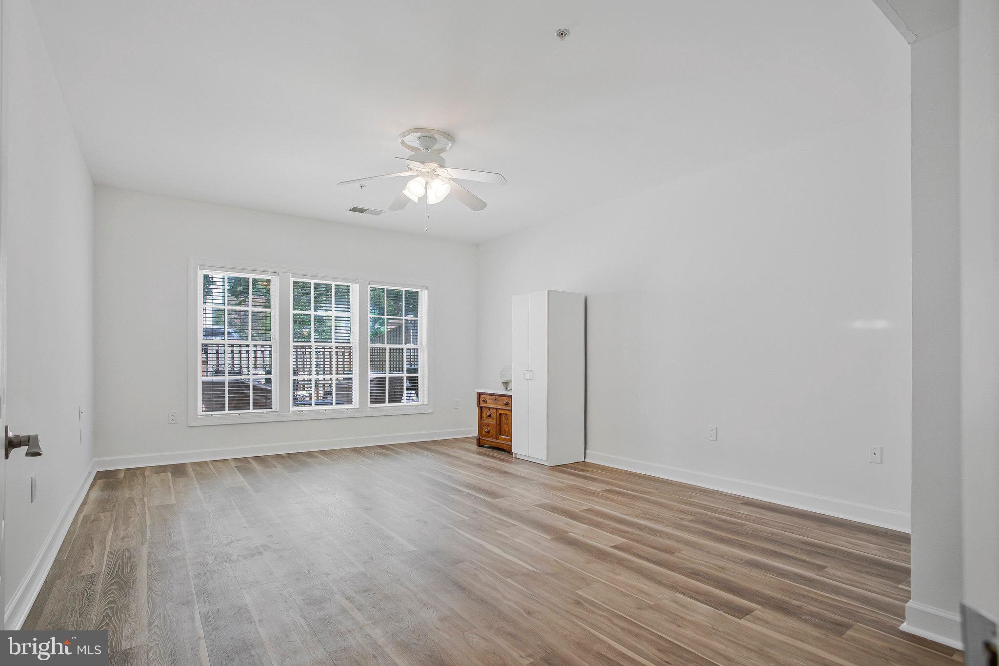 322 Hamlet Circle Edgewater, MD 21037 - Photo 10 of 21 wooden floor in an empty room with a window