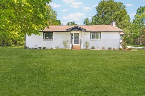 a front view of a house with a garden