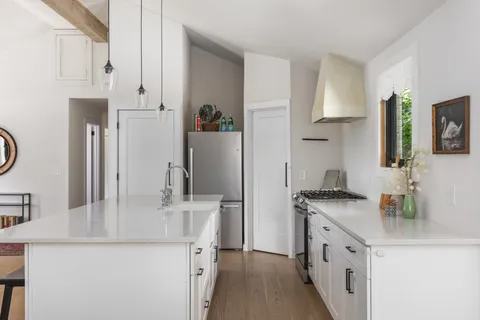 a kitchen with stainless steel appliances granite countertop a sink stove and refrigerator