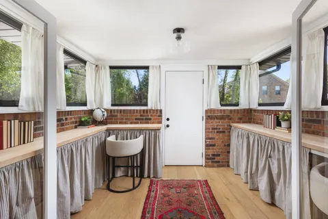 a bathroom with a tub sink and mirror