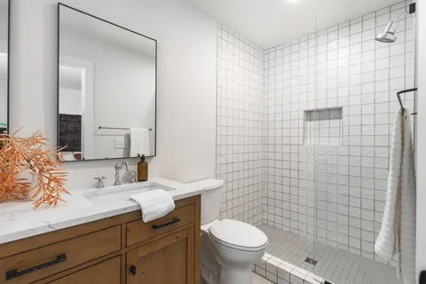 a bathroom with a sink a toilet and shower