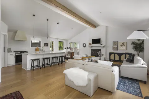 a living room with fireplace furniture and a wooden floor
