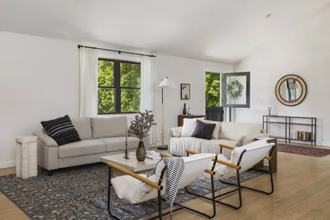 a living room with furniture and a large window