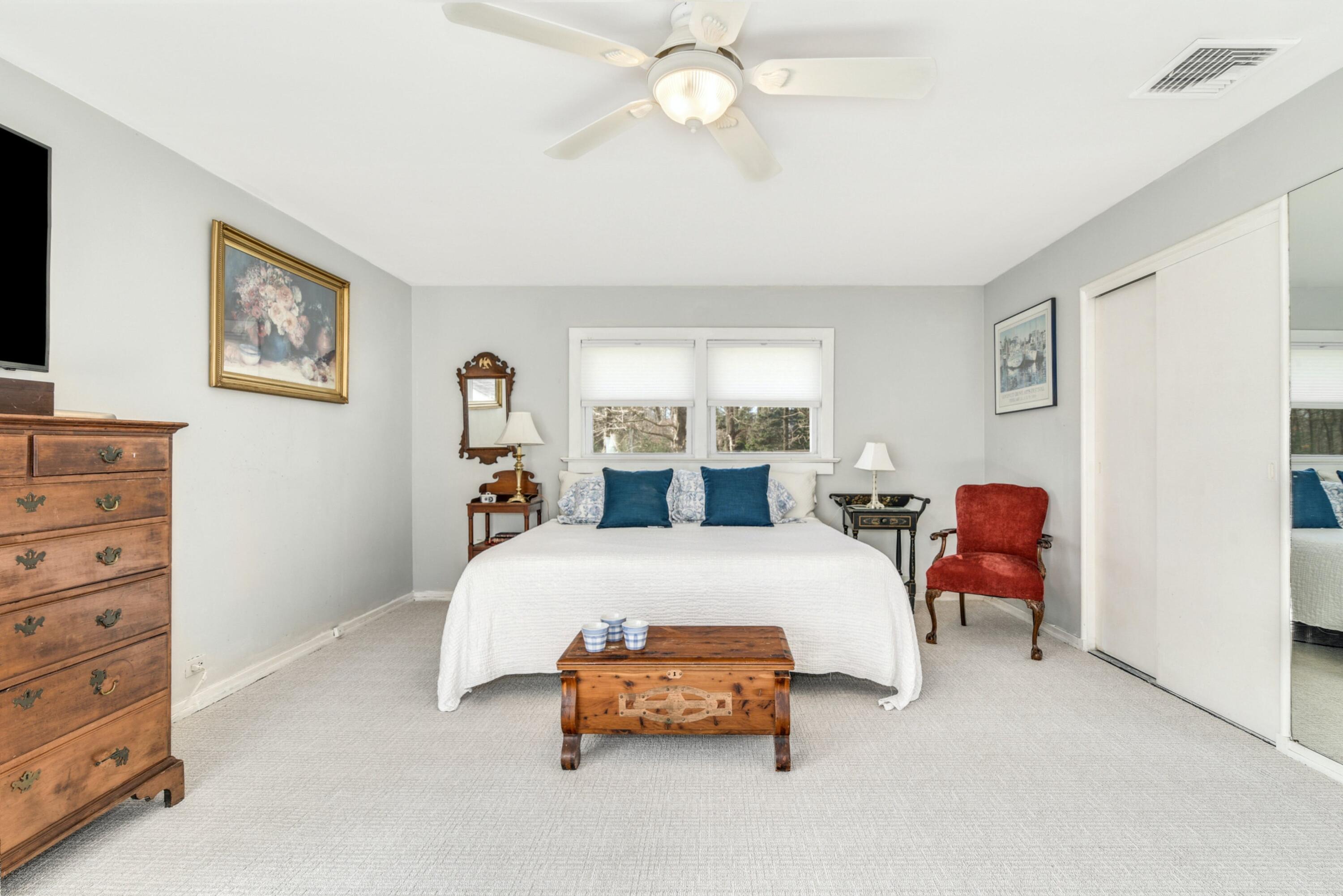 25 Goodwives River Road Darien, CT 06820 - Photo 11 of 17 a bedroom with a bed and a chandelier