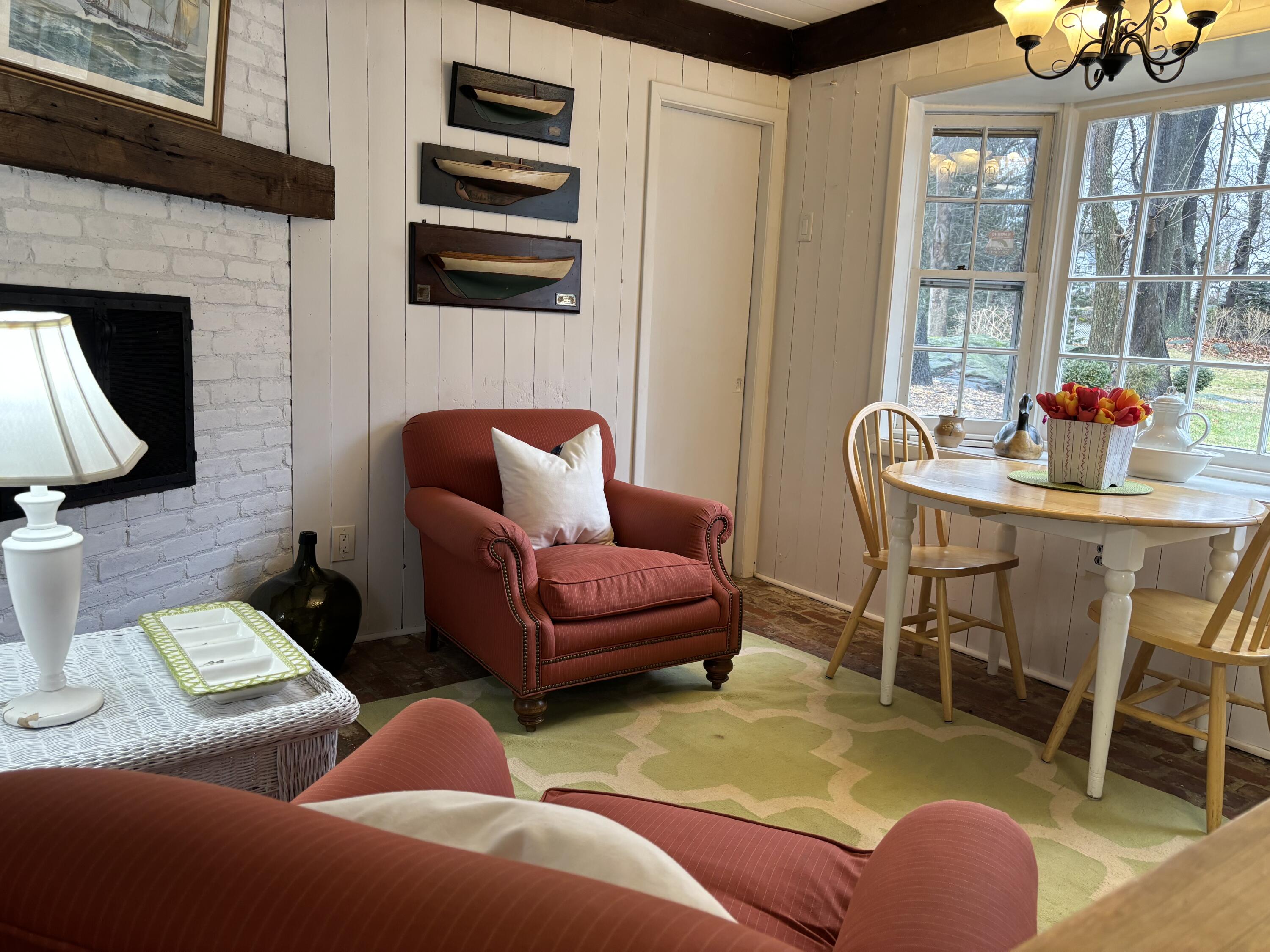 25 Goodwives River Road Darien, CT 06820 - Photo 8 of 17 a living room with furniture a flat screen tv and a fireplace