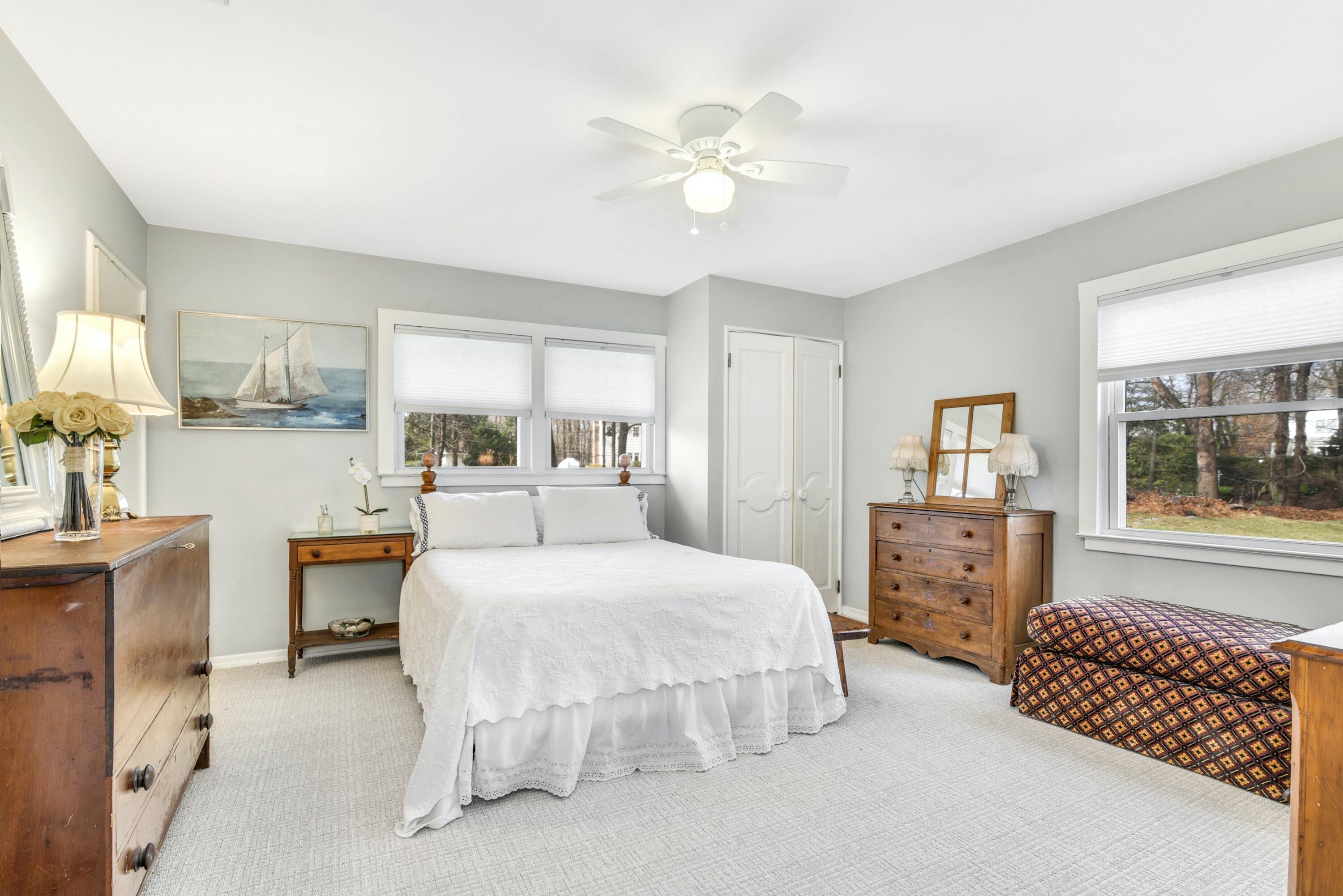 25 Goodwives River Road Darien, CT 06820 - Photo 10 of 17 a bedroom with a bed and dresser with mirror