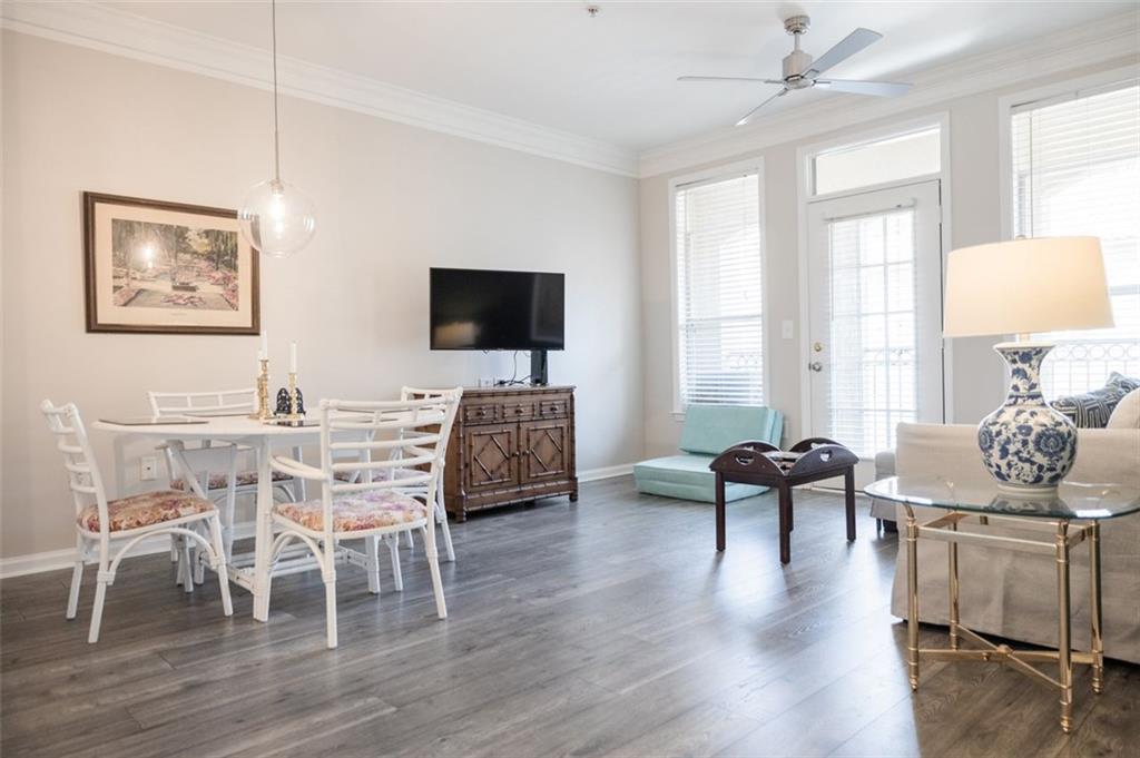 a living room with furniture wooden floor and a flat screen tv