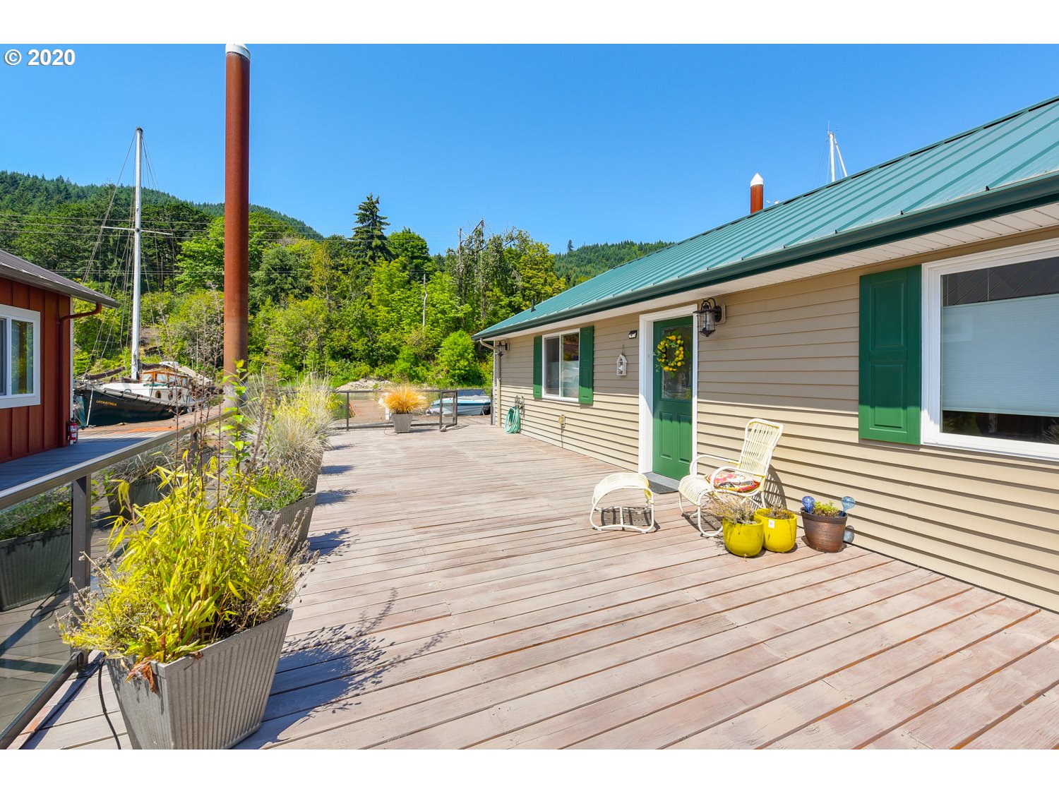 23586 Northwest St Helens Road, Unit U18 Portland, OR 97231 - Photo 7 of 30 a view of a deck with wooden floor and a potted plant