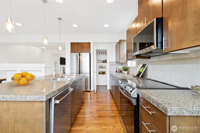 a kitchen with granite countertop a sink and a stove
