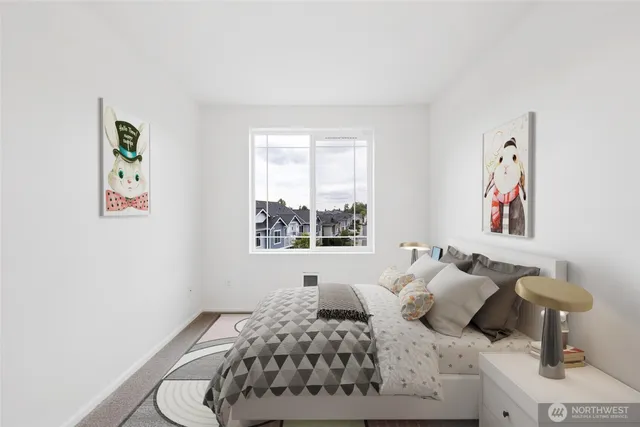 a bedroom with a large bed and a potted plant