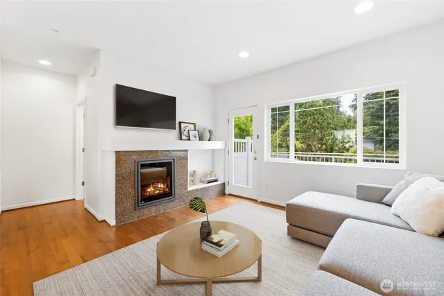 a living room with furniture a fireplace and a flat screen tv