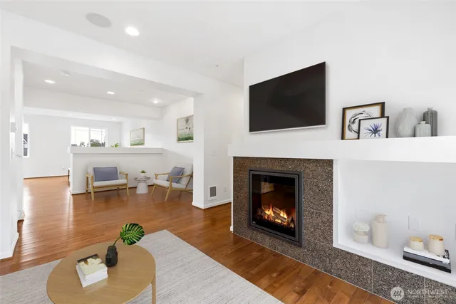 a living room with furniture a flat screen tv and a fireplace