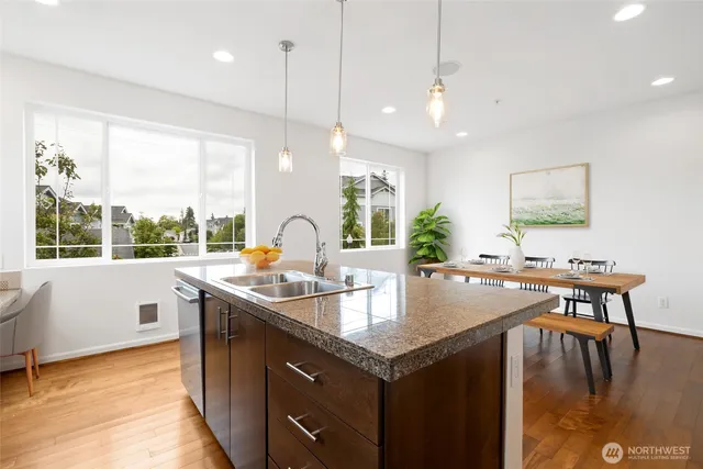 a kitchen with stainless steel appliances granite countertop a sink and a stove
