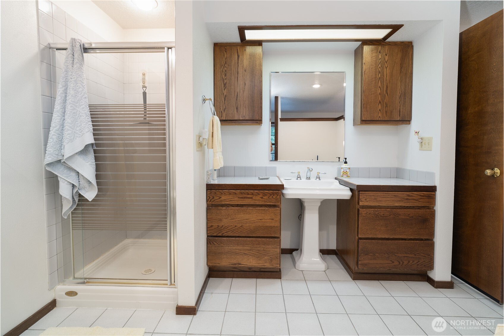 2102 Mark Street Northeast Olympia, WA 98516 - Photo 22 of 37 a bathroom with a sink a vanity and a mirror