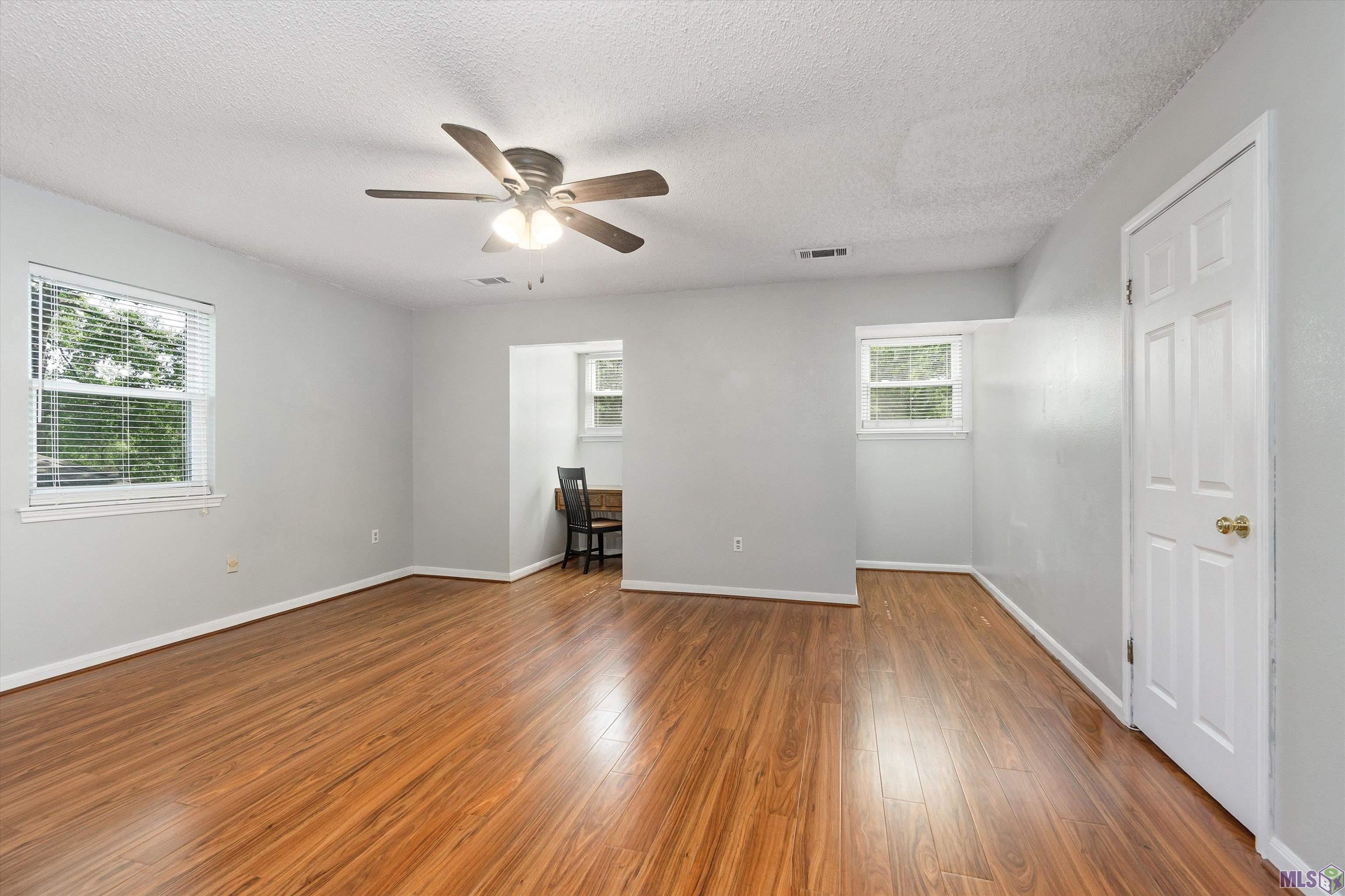 11744 Spring Meadow Drive Baton Rouge, LA 70818 - Photo 16 of 22 Bedroom with Built-in Desk and Three Closets