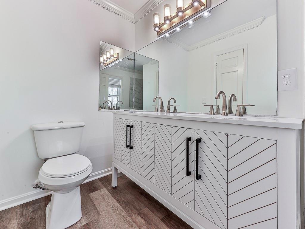 633 Butterworth Road Canton, GA 30114 - Photo 35 of 55 a bathroom with a sink a toilet and a mirror