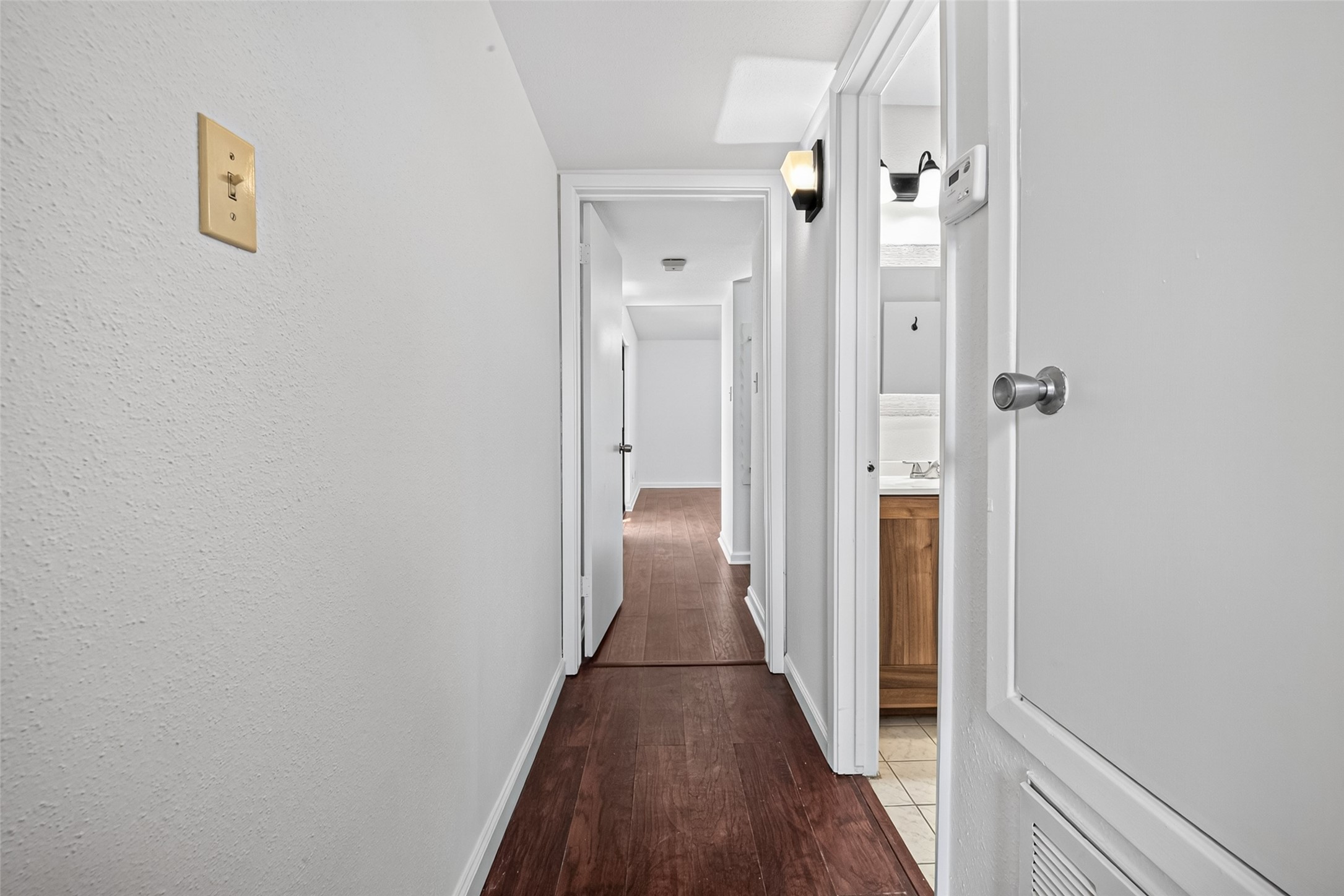 6401 Deihl Road, Unit 902 Houston, TX 77092 - Photo 14 of 35 Step into a welcoming hallway that guides you past a convenient bathroom and walk-in closet on the right, leading directly to a serene bedroom retreat.