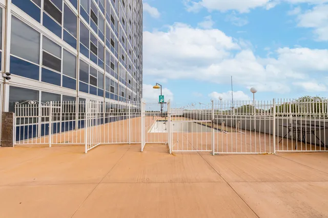 a view of a swimming pool with outdoor seating