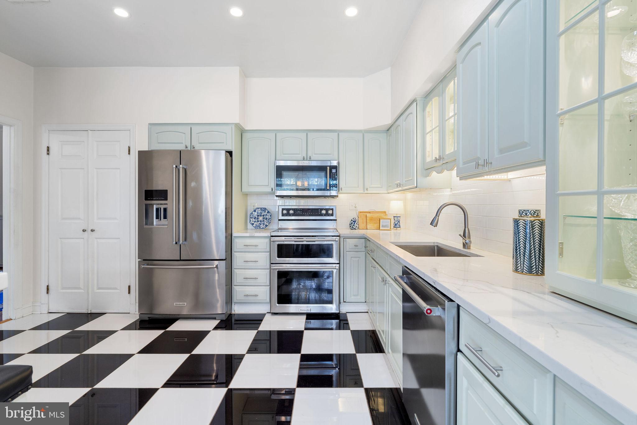 8007 Strauff Road, Unit 16 Towson, MD 21204 - Photo 15 of 49 a kitchen with a checkered floor and a refrigerator